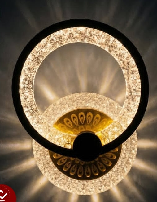 Decorative wall light fixture with crystal-like design on a dark background