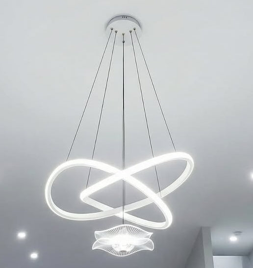 Modern pendant light with three circular designs on a ceiling.