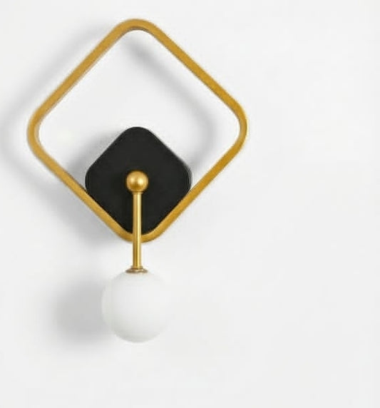 Decorative wall hook with black square, gold bar, and white sphere on a light gray background