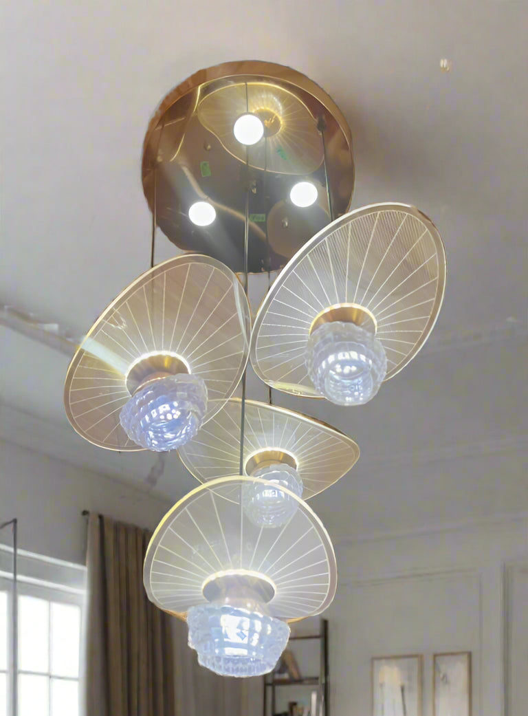 Chandelier with multiple light bulbs on a red wall