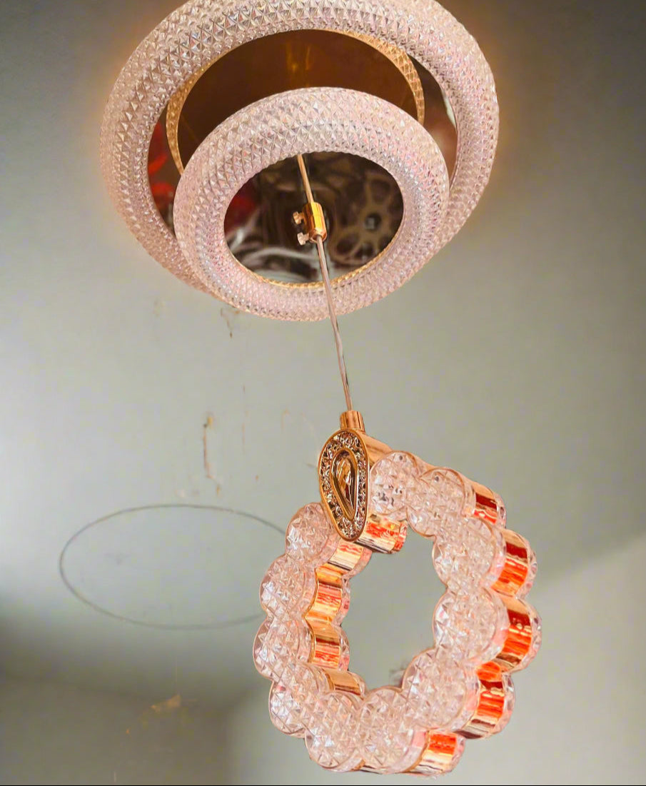 Decorative ceiling light fixture with crystal details on a neutral background