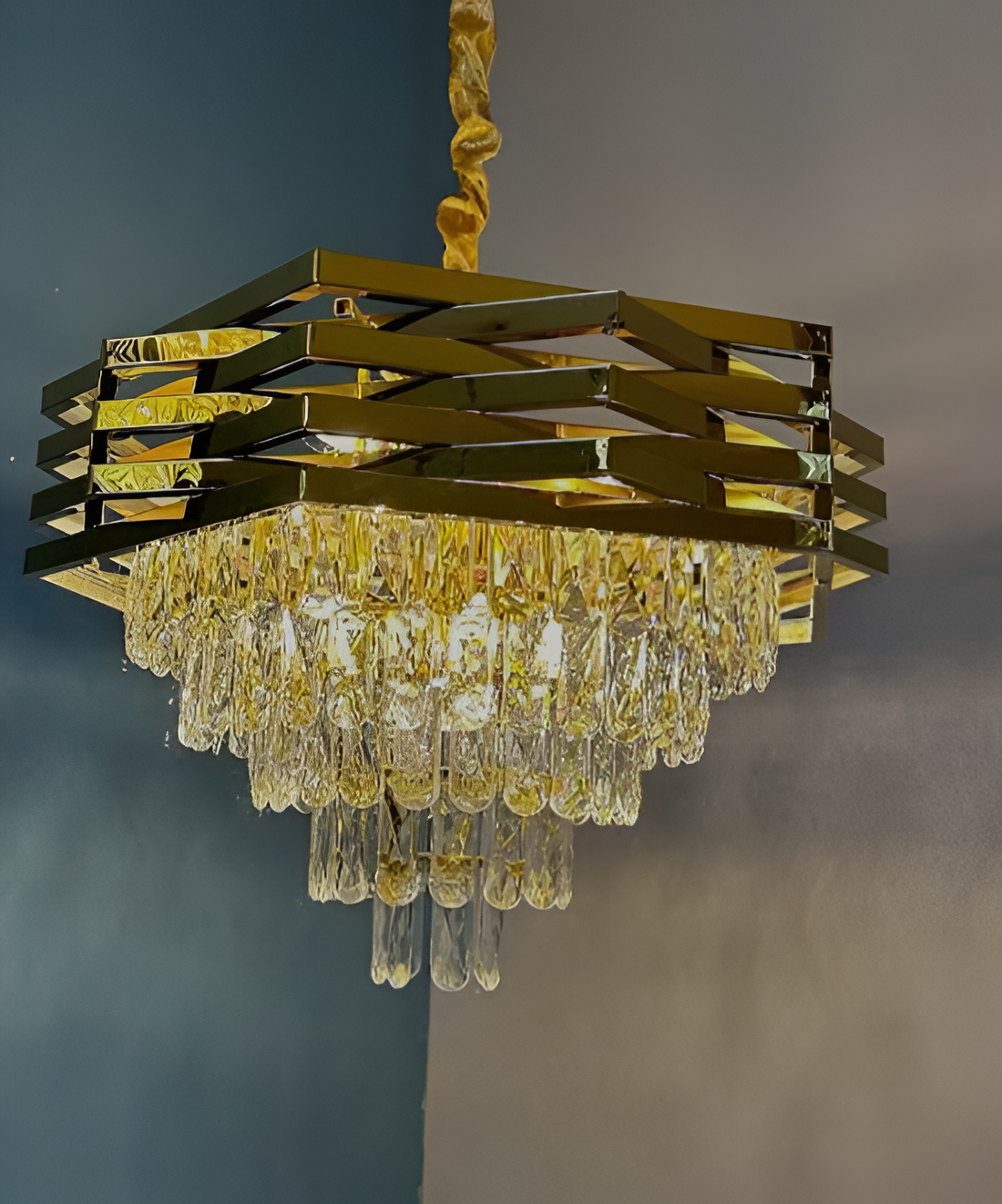 Gold chandelier with crystal accents against a dark background