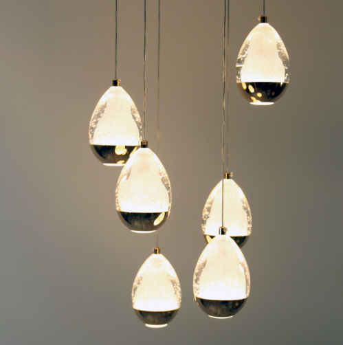 Aquadrop pendant light featuring multiple teardrop-shaped fixtures with elegant design and warm glow