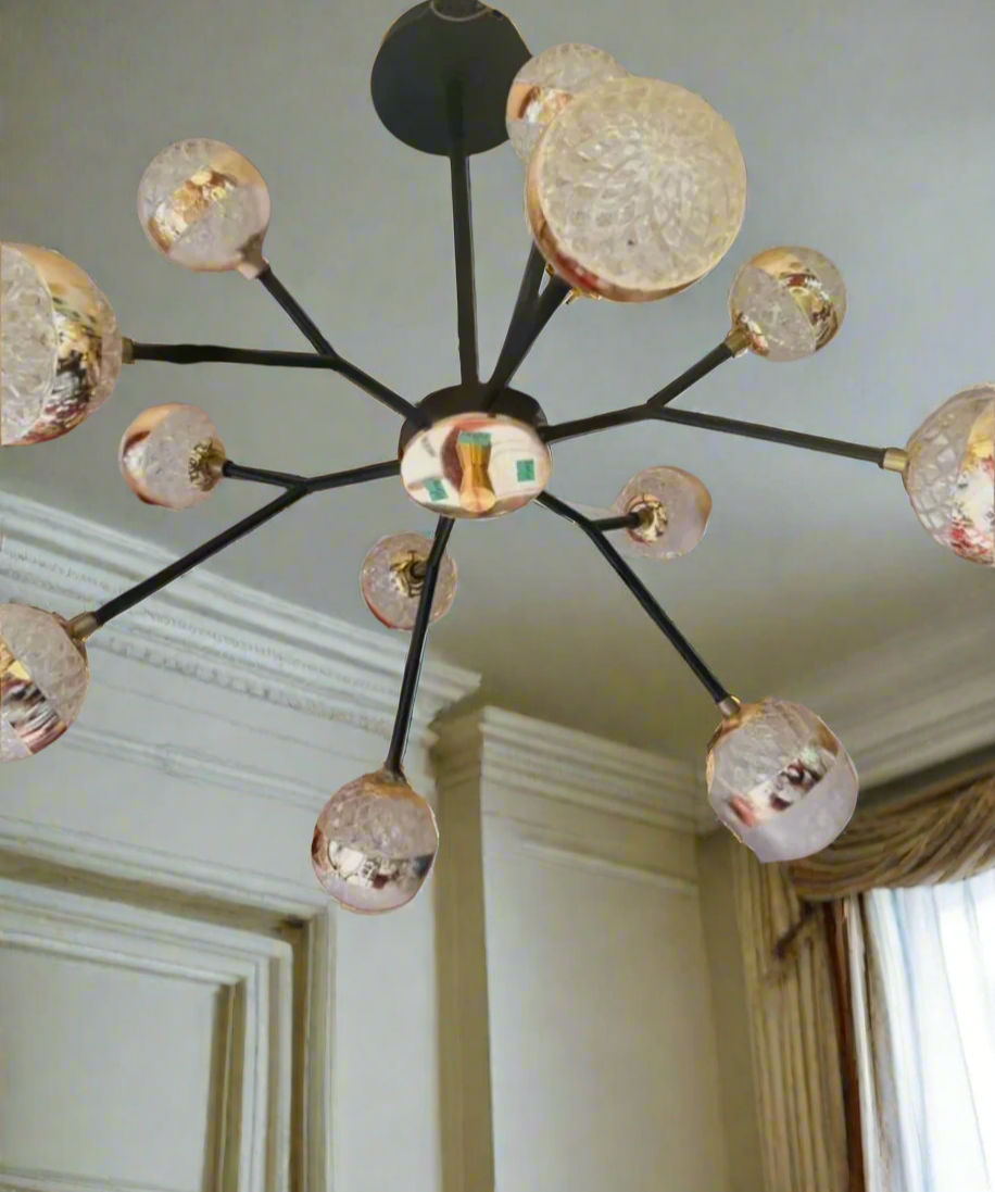 Modern chandelier with gold and black design on a ceiling