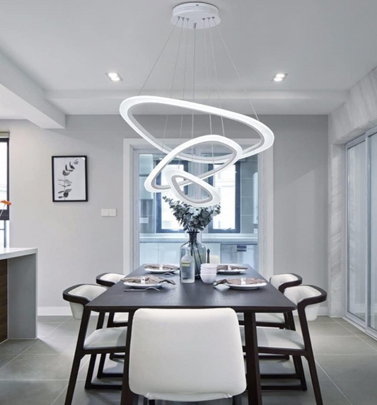 Modern dining room with Amangazini Cascading LED Ring Chandelier hanging above a black table with six chairs