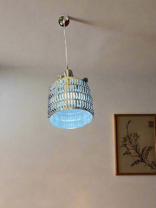 Amangazini decorative lattice lighting fixture hanging with soft blue illumination in a stylish interior