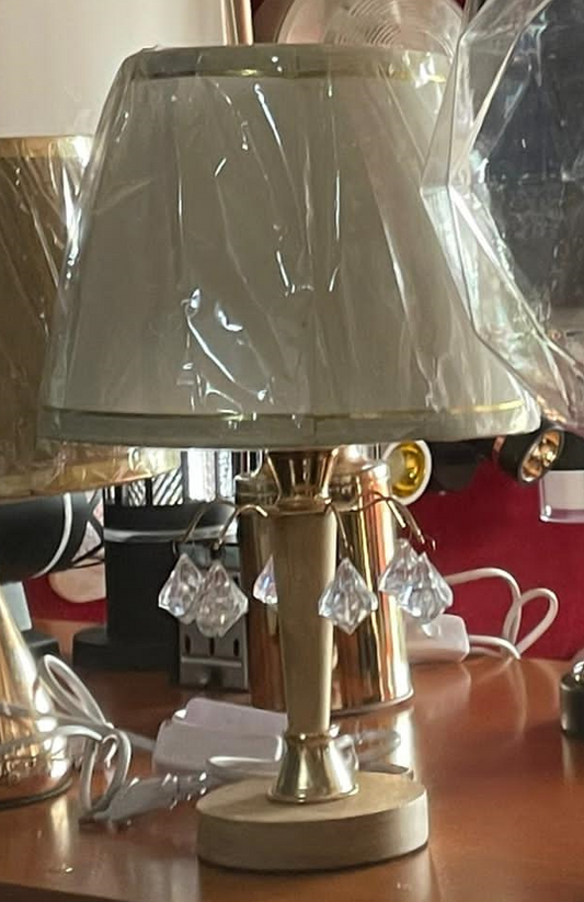 Elegant crystal table lamp with a silver base and decorative hanging crystals