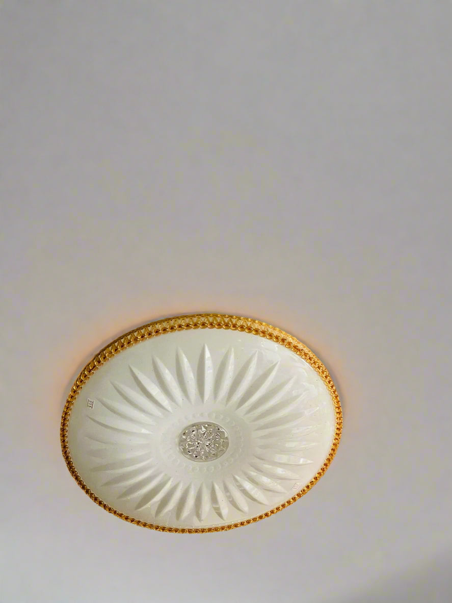Elegant golden ceiling light with floral design detail for a stylish home ambiance