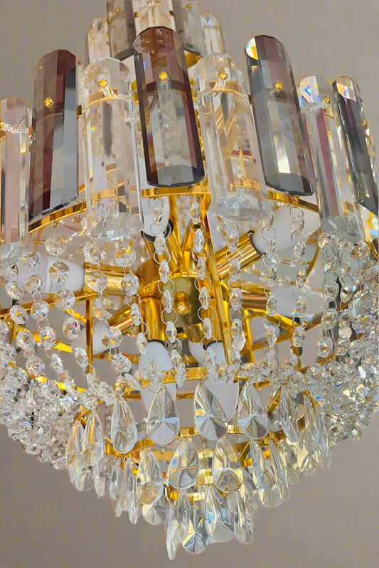 Close-up of a crystal chandelier with gold accents