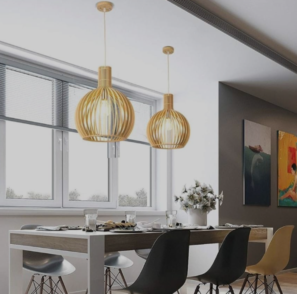 Two handcrafted wood light pendants providing warm illumination in a stylish dining area