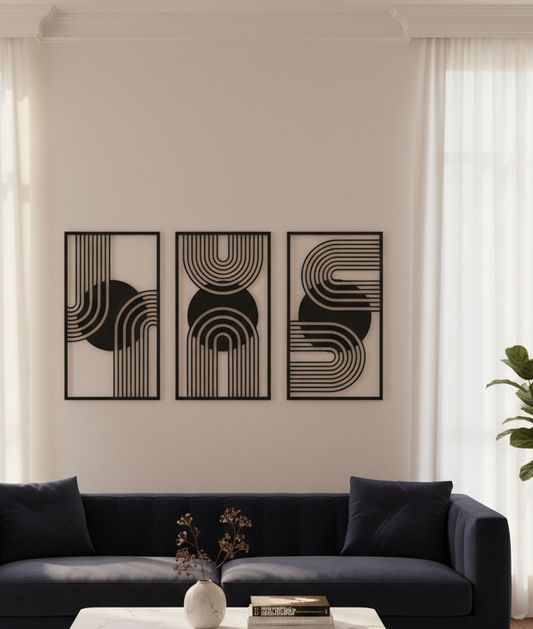 Modern living room with black abstract wall art above a dark blue sofa.