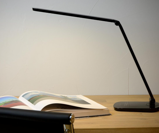 Amangazini LED Desk Lamp for Ideal Lighting on a workspace with an open book