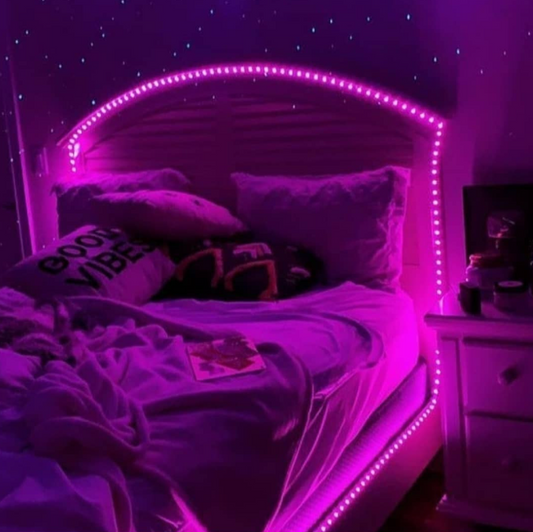 Amangazini LED strip snake light illuminating a cozy bed with purple glow and decorative pillows
