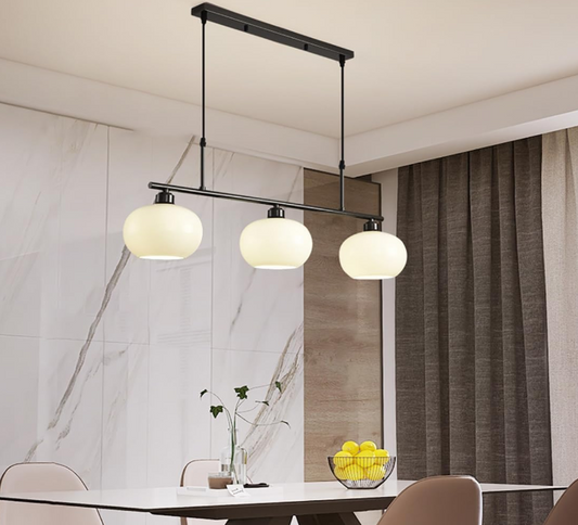 Amangazini Linea 3-Light Island Light with black frame and white glass shades over dining table