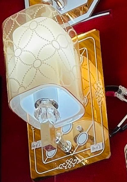 Modern crystal wall light with elegant design and decorative base for stylish interior decor
