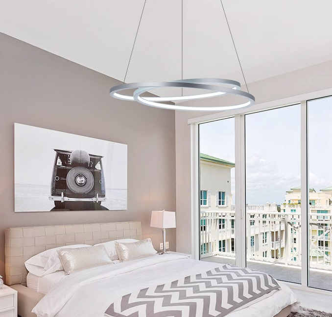 Amangazini modern dual ring chandelier light hanging above a stylish bedroom with gray decor