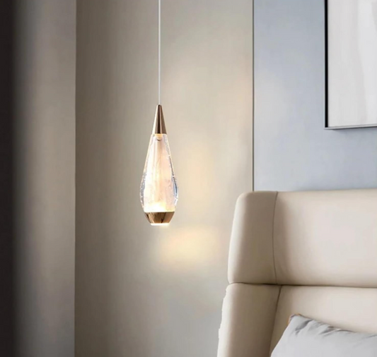 Amangazini teardrop pendant lighting with a glass shade illuminating a modern bedroom
