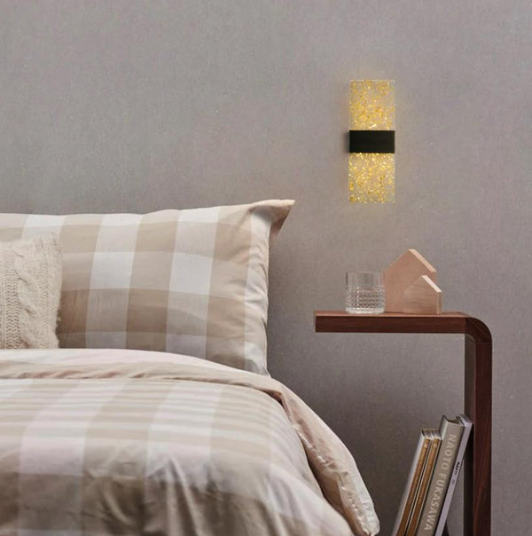 Stylish indoor wall lights illuminating a cozy bedroom with a beige checkered bedding set