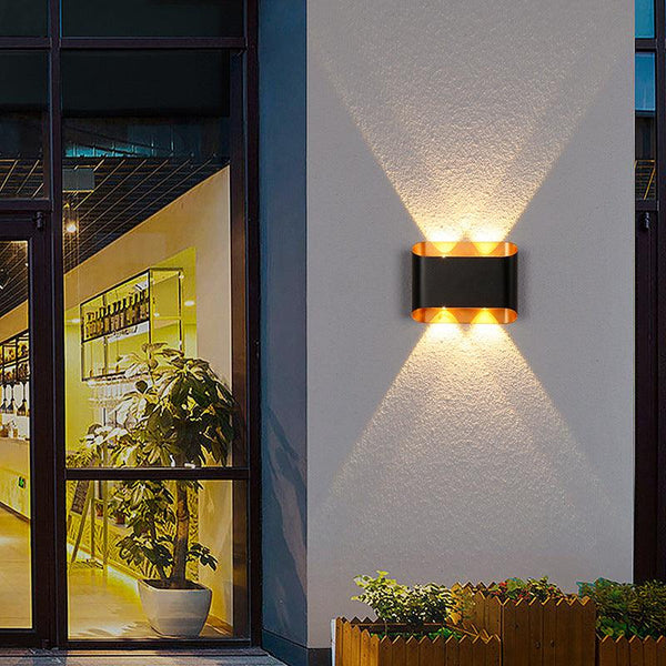 Stylish outdoor wall lights illuminating an entrance with modern design and warm lighting.