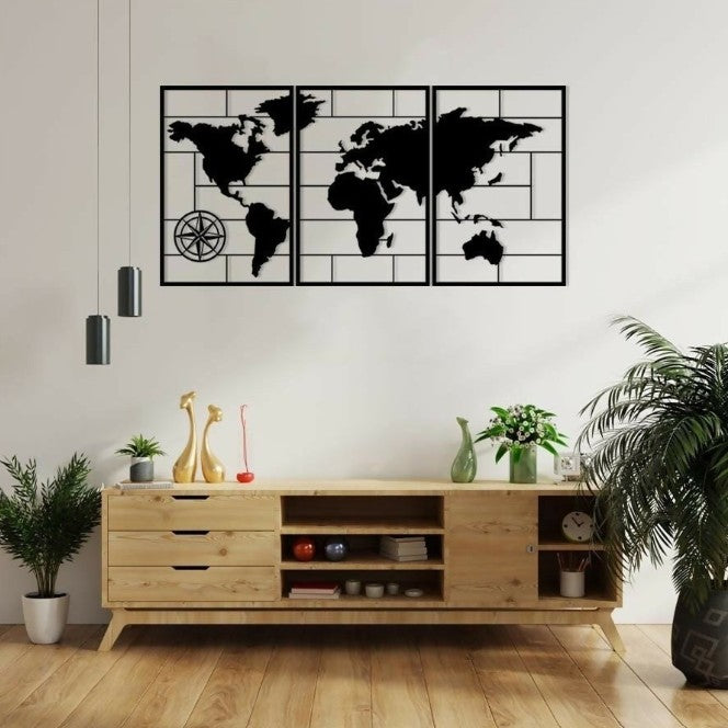 World map wall art above a wooden console table in a room with plants.