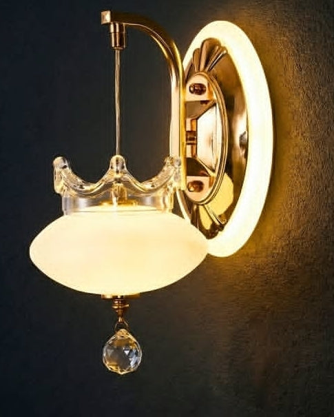 Wall-mounted light fixture with glass shade and crystal accent on a dark background