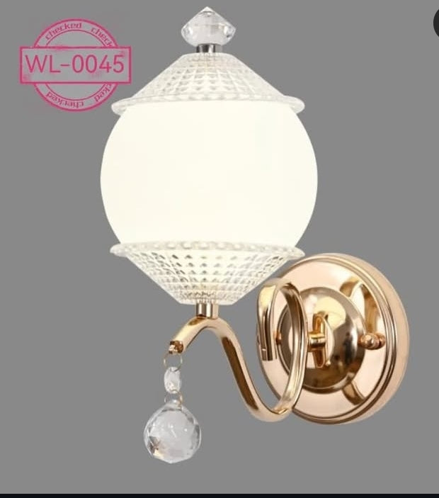 Decorative wall light fixture with crystal details on a gray background