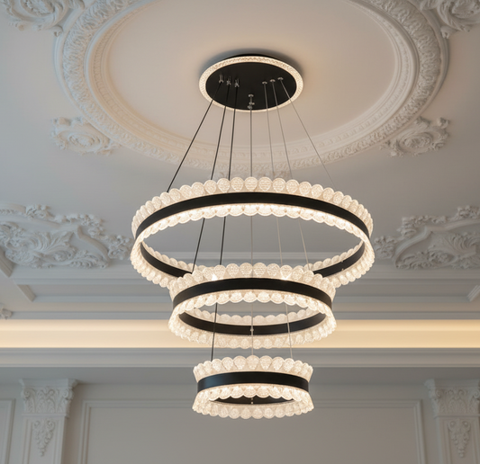 Modern chandelier hanging from a ceiling with decorative molding