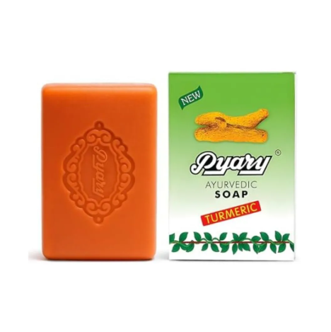 Orange ayurvedic soap bar and its packaging on a white background