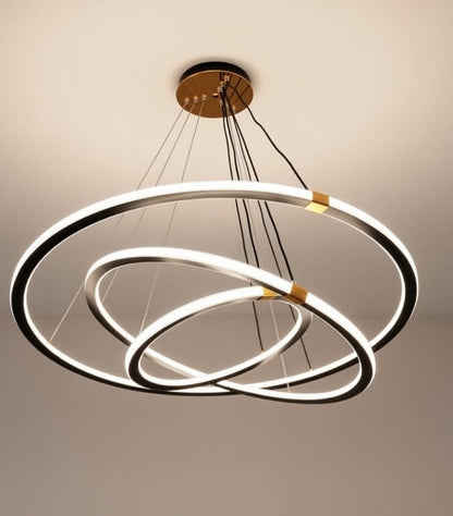 Modern chandelier with three circular rings on a neutral background