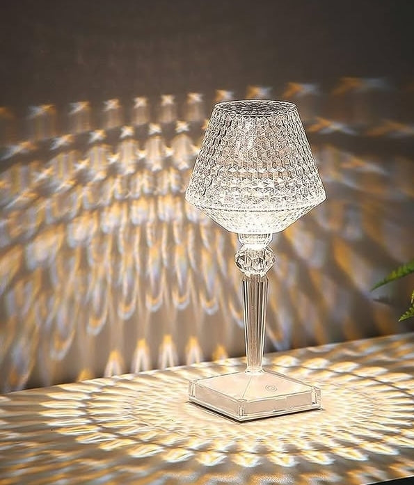 Crystal table lamp casting shadows on a textured wall