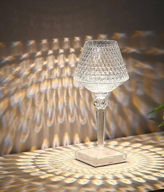 Crystal table lamp casting shadows on a textured wall