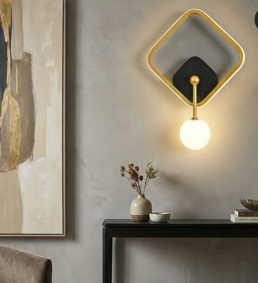 Modern wall light fixture on a neutral wall with decorative elements.