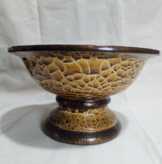 Ceramic bowl with textured brown design on a white background