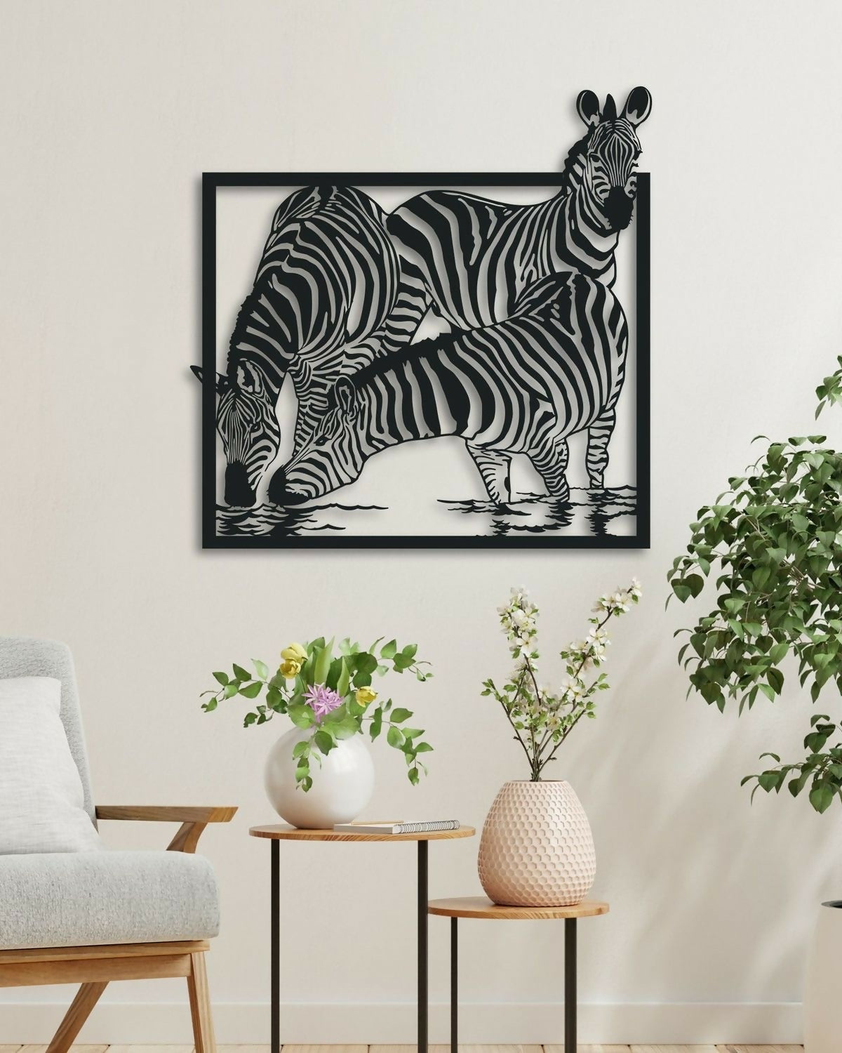 Decorative wall art of three zebras on a white wall with minimal decor.