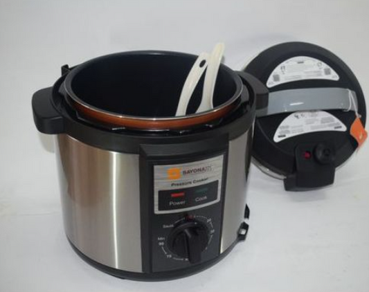 Pressure cooker with a spoon inside on a white background