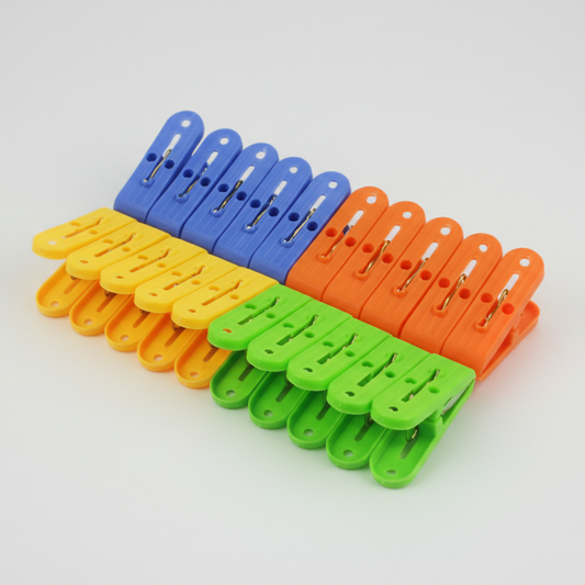 Set of colorful plastic clothespins on a white background