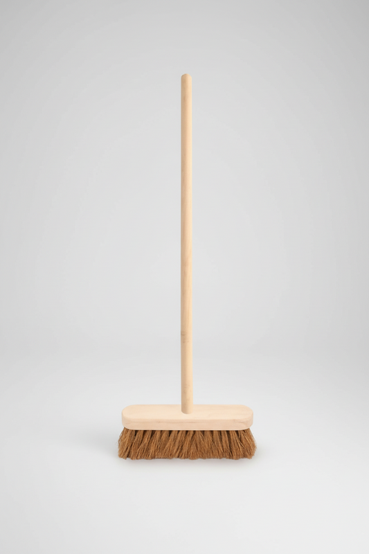 Broom with wooden handle and bristle head on a white background