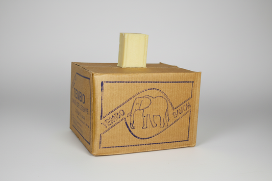 Cardboard box with a yellow block on top against a white background