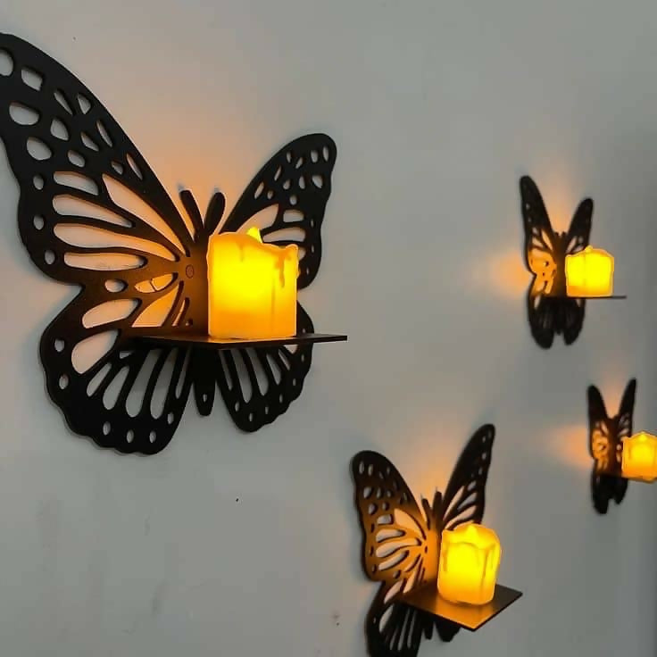 Butterfly-shaped wall sconces with candles on a white wall