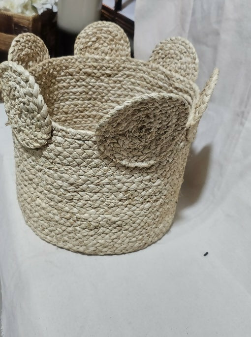 Woven basket with a crown design on a white background