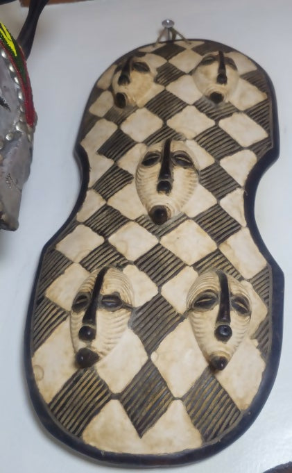 Checkered patterned object with black accents on a white background
