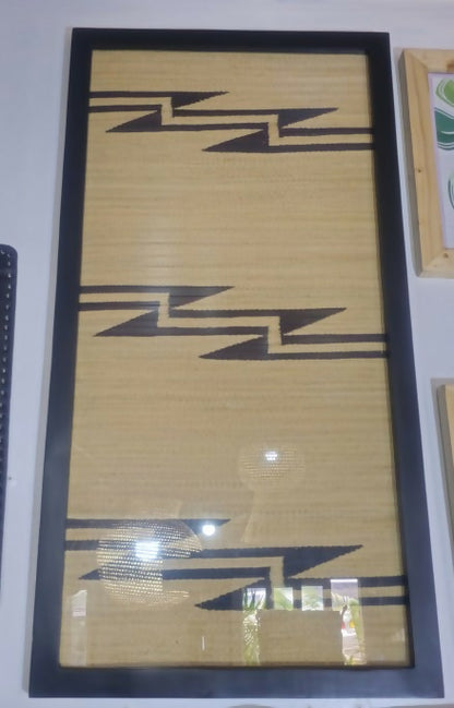 Framed artwork with geometric pattern on a plain background