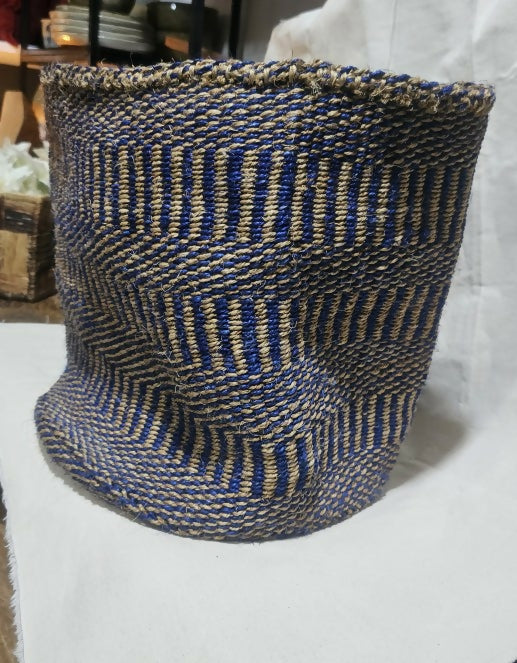 Woven basket with blue and brown pattern on a white surface