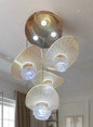 Chandelier with multiple light bulbs on a red wall