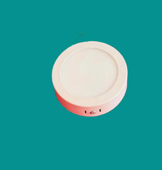 Round white panel light on a teal background