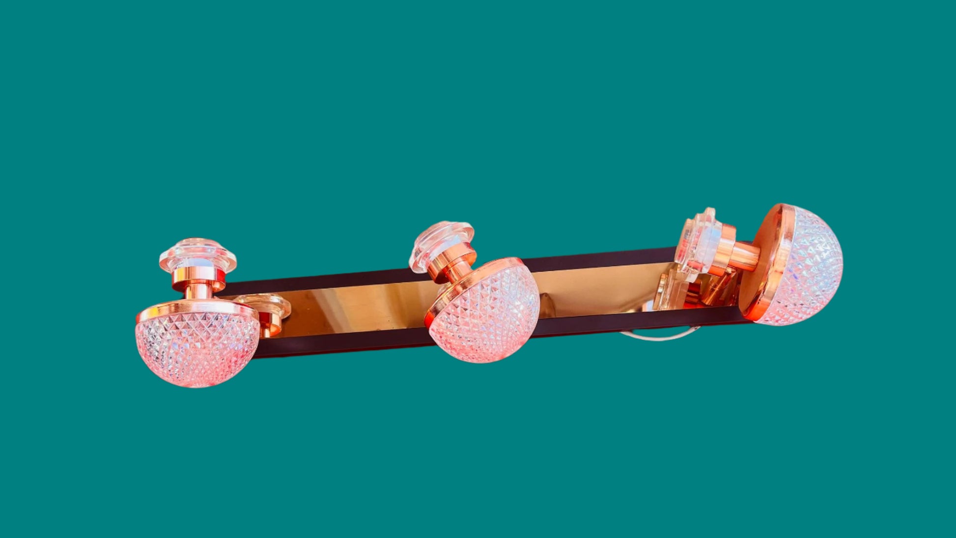 Decorative wall sconce with crystal accents on a red background