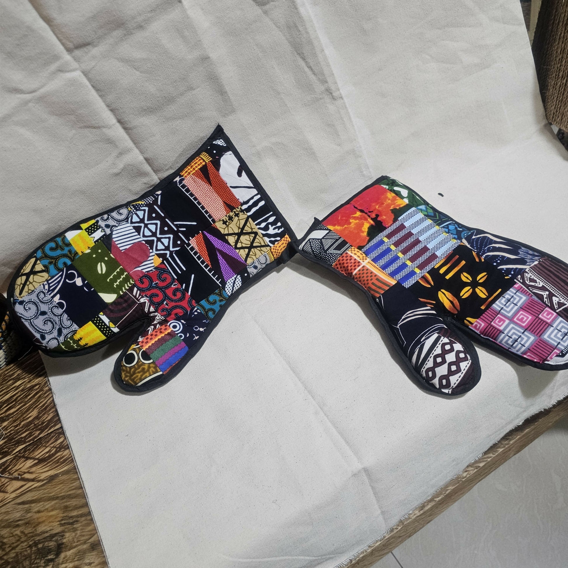 Colorful patterned oven mitts on a white surface
