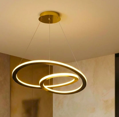Modern ceiling light fixture with two interlocking rings on a neutral background