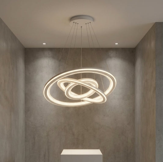 Modern pendant light fixture hanging in a room with concrete walls.