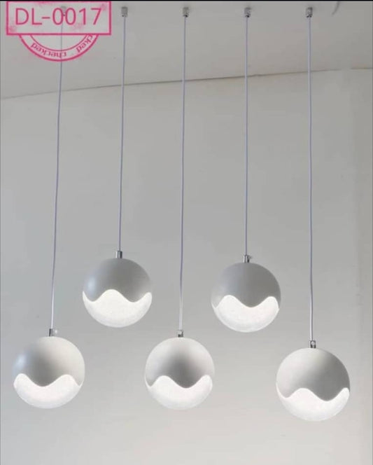 Modern pendant lights with wavy design on a plain background